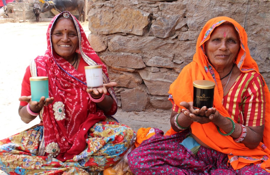 Two women showcasing there work